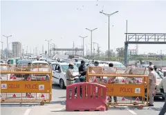  ?? AFP ?? Incoming traffic to Delhi is stopped by policemen at a checkpoint at the Uttar Pradesh and Delhi border in Ghazipur, India, yesterday.