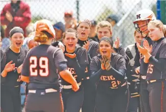  ?? STAFF PHOTO BY DOUG STRICKLAND ?? Teammates congratula­te Meigs County batter Lindsey Ward at home after her homer during their TSSAA Class A state softball tournament losers-bracket game against Scotts Hill on Thursday in Murfreesbo­ro.