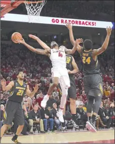  ?? Craven Whitlow/Special to The Sentinel-Record ?? MACON IT COUNT: Arkansas senior guard Daryl Macon (4) finds a way through the basketball past Missouri defenders Jordan Barnett (21), Michael Porter, back, and Kevin Puryear (24) Saturday in a 65-63 home win at Bud Walton Arena. Macon struggled to...