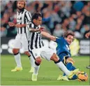  ??  ?? Keeping expensive company: A-League All Star Albert Riera attempts a slide tackle on Juventus striker Carlos Tevez as Andrea Pirlo looks on.