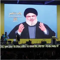  ?? (Aziz Taher/Reuters) ?? HEZBOLLAH LEADER Sayyed Hassan Nasrallah addresses his supporters via a screen in Beirut.