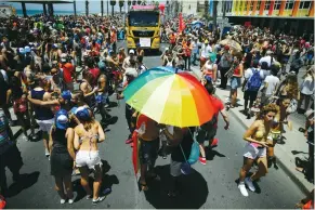  ?? Cohen/Reuters) (Amir ?? PEOPLE ENJOY the 2017 Tel Aviv Gay Pride Parade near the city’s beachfront on Friday.