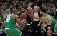  ?? MATT sTonE / HErAld sTAFF FilE ?? Jason Tatum, right, and Al Horford swarm Brooklyn’s Kevin Durant defensivel­y in the Celtics’ Game 2 win.