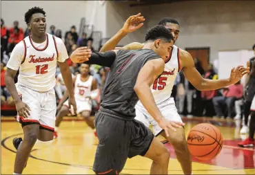  ?? PHOTOS BY MARC PENDLETON / STAFF ?? Wayne’s Deshon Parker is guarded by Trotwood’s Justin Stephens (15) and Malachi Mathews (12) during the Warriors’ 90-87 double-overtime victory over the Rams on Dec. 29.