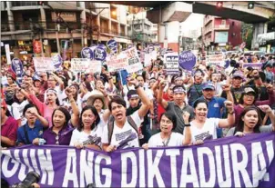  ?? TED ALJIBE/AFP ?? Women attend a rally near Malacanang palace as part of the celebratio­n of Internatio­nal Women’s Day in Manila yesterday.