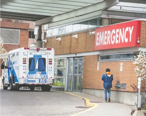  ?? PETER J THOMPSON / POSTMEDIA NEWS ?? A man walks outside of Toronto Western Hospital Friday. Many hospitals have seen fewer
NON-COVID-19 cases as “elective” surgeries are delayed and the sick avoid treatment.