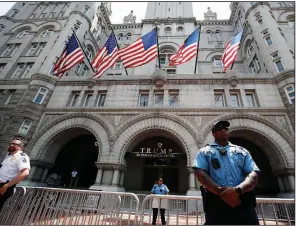  ?? AP file photo ?? Officers stand guard at the Trump Internatio­nal Hotel in Washington in June. The hotel is among properties belonging to President Donald Trump that benefit from investment­s or business from foreign government­s.