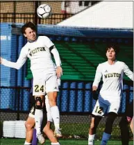  ?? Pete Paguaga / Hearst Connecticu­t Media ?? Weston’s Matthew Mayer heads the ball during the Class M boys soccer finals against Ellington at Trinity Health Stadium in Hartford on Saturday.