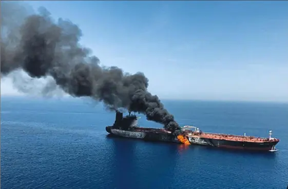  ?? ISNA/Associated Press ?? An oil tanker is on fire Thursday in the sea of Oman. Two oil tankers near the strategic Strait of Hormuz were reportedly attacked on Thursday, leaving one ablaze and adrift as sailors were evacuated from both vessels and the U.S. Navy rushed to assist. Mideast tension flares