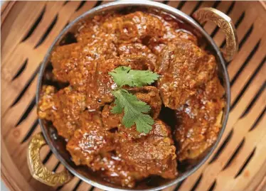  ?? Photos by Steve Gonzales / Staff photograph­er ?? Phat’s Eatery’s Beef Rendang can be savored by itself with sticky steamed rice or with nasi lemak, a little buffet of flavors and textures arranged on a banana-leaf-lined platter and served with aromatic coconut rice.