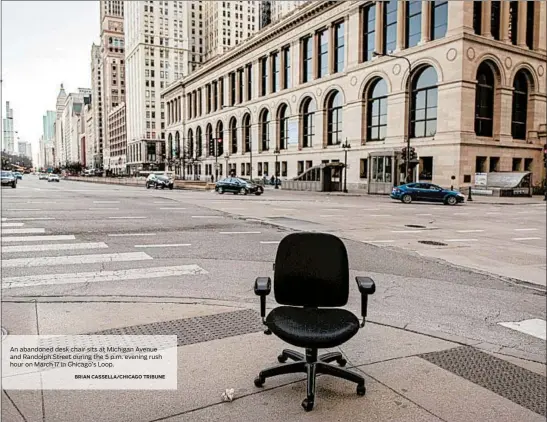  ?? BRIAN CASSELLA/CHICAGO TRIBUNE ?? An abandoned desk chair sits at Michigan Avenue and Randolph Street during the 5 p.m. evening rush hour on March 17 in Chicago’s Loop.