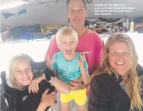  ??  ?? TERROR ON THE HIGH SEAS: Louise and Lachin Turner with children Siara and Kai and cat Spook aboard their catamaran.