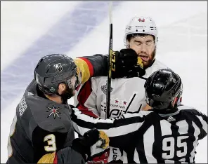  ?? AP/ROSS D. FRANKLIN ?? Vegas Golden Knights defenseman Brayden McNabb (left) punches Washington Capitals right wing Tom Wilson as linesman Jonny Murray tries to break them up during the third period in Game 1 of the NHL Stanley Cup Finals on Monday in Las Vegas.