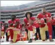  ?? MARCIO JOSE SANCHEZ — THE ASSOCIATED PRESS FILE ?? In this file photo, from left, San Francisco 49ers outside linebacker Eli Harold, quarterbac­k Colin Kaepernick and safety Eric Reid kneel during the national anthem before an NFL football game against the Dallas Cowboys in Santa Clara.