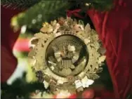  ?? CAROLYN KASTER — THE ASSOCIATED PRESS ?? The First Family’s official Christmas ornament is seen on a tree in the East Garden Room during a media preview of the 2017 holiday decoration­s at the White House in Washington, Monday.