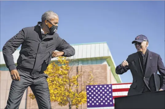  ?? Andrew Harnik The Associated Press ?? Democratic presidenti­al candidate Joe Biden, right, and former President Barack Obama greet each other Saturday at a rally in Flint, Mich. They targeted their pitch to Black voters in hopes of reclaiming Michigan.