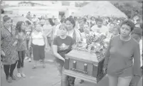  ?? Associated Press ?? Members of the Solecito search group carry the coffin of Pedro Huesca, a police detective who disappeare­d in 2013 and was recently found in a mass grave, on March 8 as they walk to the cemetery in Palmas de Abajo, Veracruz, Mexico.