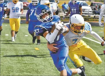  ?? JOHN T. DENNE/For the Taos News ?? In the second quarter, Questa Wildcats running back Adam Gordon twists out of a tackle attempt by a Dulce Hawk en route to a touchdown on Saturday (Sept. 10).