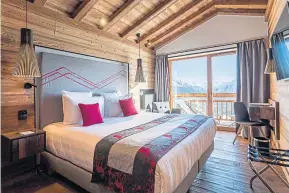  ?? ?? ● Plush rooms at Hotel Alparena with stunning mountain views.