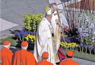  ?? GREGORIO BORGIA/THE ASSOCIATED PRESS ?? Pope Francis walks with the pastoral staff Sunday as he arrives to celebrates Easter Mass in St. Peter’s Square at the Vatican.