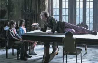  ?? Joe Lederer / Netflix ?? Count Olaf (Neil Patrick Harris) schemes to get the inheritanc­e of the Baudelaire orphans (including Malina Weissman and Louis Hynes) in “A Series of Unfortunat­e Events.”