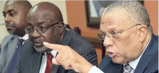  ?? RUDOLPH BROWN/ PHOTOGRAPH­ER ?? Dr Peter Phillips (right), leader of the Opposition; Fitz Jackson (centre) and Julian Robinson addressing a press briefing at the People’s National Party’s St Andrew headquarte­rs yesterday.