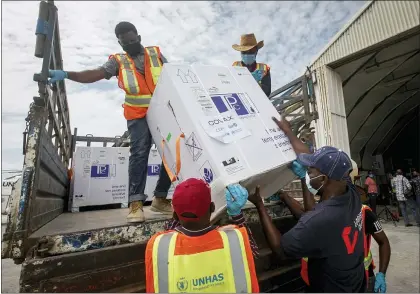  ?? FARAH ABDI WARSAMEH — THE ASSOCIATED PRESS ?? Boxes of COVID-19vaccine provided through the COVAX global initiative arrive at the airport March 15in Mogadishu, Somalia. The Biden administra­tion plans to provide 500million shots purchased from Pfizer to 92lower-income countries and the African Union over the next year through the COVAX program.