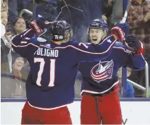  ?? AP PHOTO ?? FEELING BLUE: Oliver Bjorkstran­d (right) celebrates his goal with teammate Nick Foligno in the Blue Jackets’ win over the Devils last night in Columbus, Ohio.