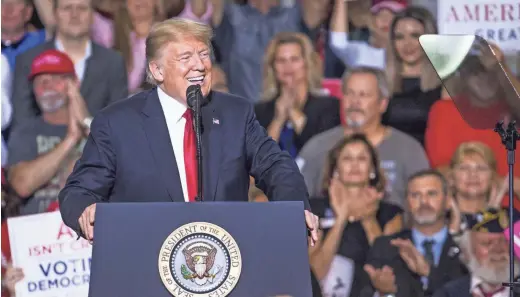  ??  ?? President Donald Trump speaks inside the Internatio­nal Air Response Hangar on Friday at Phoenix-Mesa Gateway Airport. The president was in the Valley to promote the U.S. Senate candidacy of Rep. Martha McSally, R-Ariz. During Friday’s rally, Trump called McSally “a great fighter.” TOM TINGLE/THE REPUBLIC