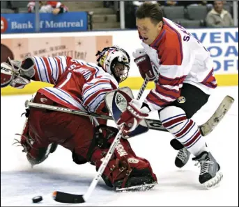  ?? ADRIAN WYLD/THE CANADIAN PRESS VIA AP ?? Playing for Team Canada, Borje Salming (right) tries to control the puck past Russia’s Sergey Kostyukhin during a break in the play for penalty shots in third-period action the 2005 Legends Classic Tour game, in 2005, in Toronto. Salming, who starred for the Toronto Maple Leafs over 16 seasons, has died at 71. He had Lou Gehrig’s disease.