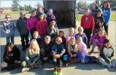  ??  ?? Left: Students from Grade 4B at Jennie Emery Elementary School in Coaldale bring food out to the Drive Away Hunger trailer and celebrate their hard work.