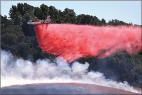  ?? (AP/The Press Democrat/Kent Porter) ?? A pilot maneuvers Cal Fire tanker 85 from the Sonoma Air Attack Base for a drop Friday on the right flank of the San Antonio Fire west of Petaluma, Calif.