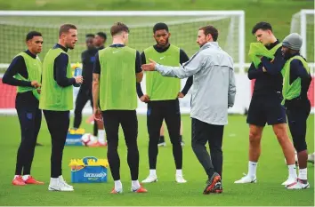  ?? AFP ?? England manager Gareth Southgate with his players during training at St George’s Park on Tuesday, ahead of their internatio­nal friendly football match against Spain tomorrow.