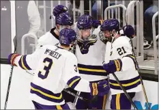  ?? Michael Dwyer / Associated Press ?? Minnesota State’s David Silye (10) celebrates his goal with teammates during the third period of Thursday’s Frozen Four semifinal game against Minnesota in Boston.