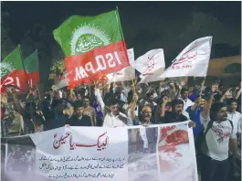  ?? (Akhtar Soomro/Reuters) ?? SHI’ITE SUPPORTERS of the Imamia Student Organizati­on chant slogans as they condemn a terrorist blast in Parachinar, during a demonstrat­ion in Karachi in March.