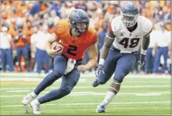  ?? Rich Barnes / Getty Images ?? Eric Dungey of the Syracuse Orange runs with the ball past Kevon Jones of Uconn during the first quarter.