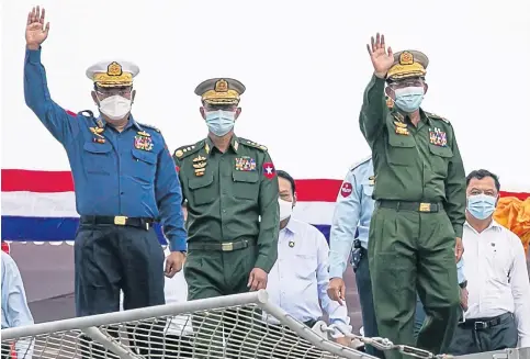  ?? ?? Myanmar junta chief Senior Gen Min Aung Hlaing (right) waves during the inaugurati­on of a new military coast guard station in Yangon on Oct 6 last year.