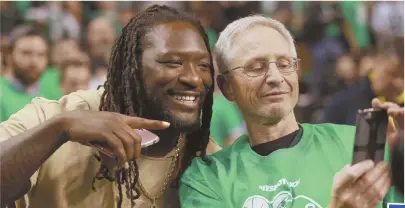  ?? STAFF PHOTOS BY MATT WEST ?? Patriot LeGarrette Blount, far left, poses with a fan before Game 7 of the Eastern Division Semifinals at TD Garden last night, while supermodel Alessandra Ambrosio takes a selfie.