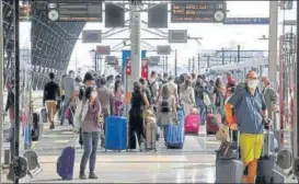  ??  ?? Commuters wearing protective face masks are seen on a platform at Milan central station, as Italy eases movement between regions and unwinds its rigid coronaviru­s lockdown. REUTERS