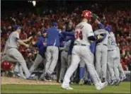  ?? PABLO MARTINEZ MONSIVAIS — ASSOCIATED PRESS ?? As Nationals’ Bryce Harper walks from the field, Dodgers celebrate their Game 5 National League Division Series win