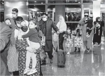  ?? KARIM JAAFAR/GETTY-AFP ?? Evacuees from Afghanista­n arrive Friday at Hamad Internatio­nal Airport in Qatar’s capital Doha.