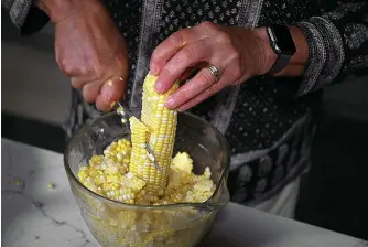  ?? Tribune News Service ?? ■ Cutting kernels from the cob can be a messy chore. But standing the ear up in a bowl means the kernels will gather there instead of all over your cutting board and countertop.