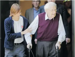  ?? MARKUS SCHREIBER/The Associated Press ?? Former SS guard Oskar Groening, 94, leaves a German court Wednesday after he was
convicted on 300,000 counts of accessory to murder at the Auschwitz death camp.