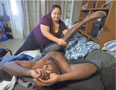  ?? PHOTOS BY CHERYL EVANS/THE REPUBLIC ?? Stephanie Little helps her fiance, Edward Brown, stretch in the morning. Brown is paralyzed after being shot by a Phoenix police officer. Brown is suing, and police have charged him with assault.