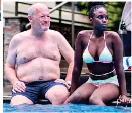  ?? ?? Relaxing: The pair sit on the poolside at a Rwandan hotel