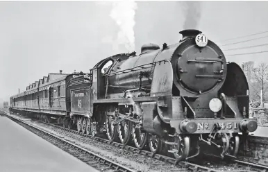  ?? Revd A C Cawston/John Whiteley Collection ?? No E451 Sir Lamorak has called at Templecomb­e with an Exeter to Salisbury all-stations passenger train comprised entirely ex-L&SWR stock. The view is recorded after 2 May 1929 when No E451 emerged from Eastleigh Works after its first general repair. Now carrying boiler No 799 (originally fitted to No E799 Sir Ironside), the tender coal rails have been plated over. The locomotive had gained its smoke deflectors in 1927. Allocated to Nine Elms at this time, No E451 is probably being run-in before returning to the shed’s principal Waterloo to Salisbury and Exeter duties. It was west of Salisbury that the ‘N15s’ were able to show their speed capabiliti­es on the descents towards Axminster and Broad Clyst.