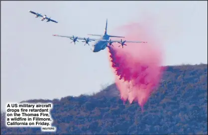  ?? REUTERS ?? A US military aircraft drops fire retardant on the Thomas Fire, a wildfire in Fillmore, California on Friday.