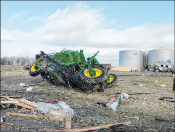  ?? Amber Arnold
The Associated Press ?? Farm equipment is left damaged after a tornado struck in Evansville, Wis., on Friday.