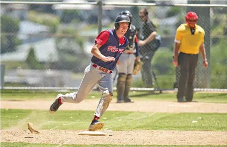  ?? Photos: Nev Madsen ?? QUALTY HIT: Brenton Althaus rounds first base for the Toowoomba Rangers in their huge 25-0 defeat of Redcliffe at Commonweal­th Oval on Sunday.