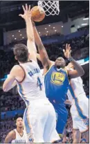  ?? SUE OGROCKI/ AP ?? Warriors rookie Draymond Green ( 23) shoots between the Thunder’s Nick Collison ( 4) and Kevin Martin.